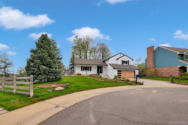 view of front of house featuring fence, an attached garage, driveway, and a front lawn