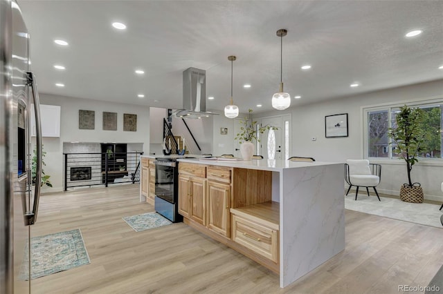 kitchen featuring stainless steel appliances, baseboards, island range hood, and light wood-style flooring