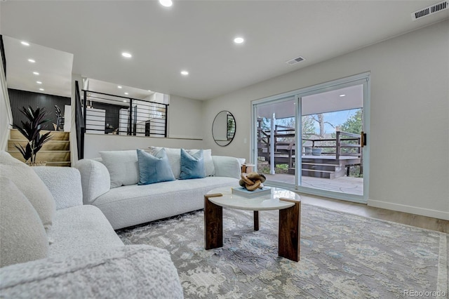 living room with baseboards, recessed lighting, wood finished floors, and visible vents