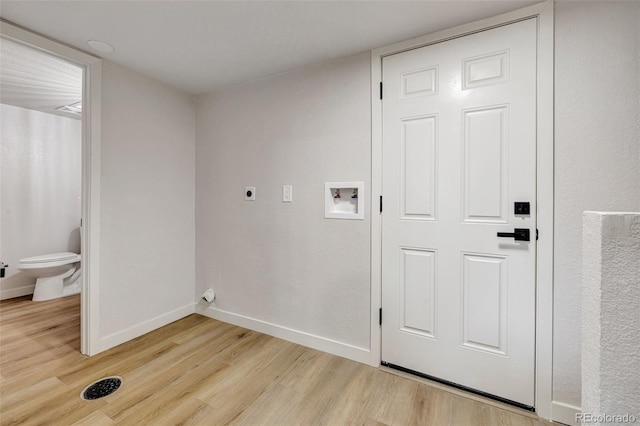 laundry room featuring light wood-style floors, hookup for a washing machine, baseboards, and electric dryer hookup