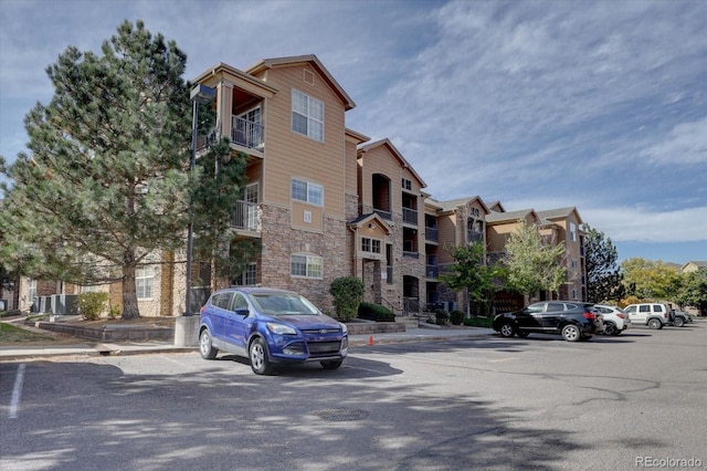 view of property with uncovered parking