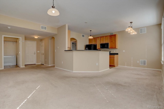 unfurnished living room with light carpet, arched walkways, and visible vents