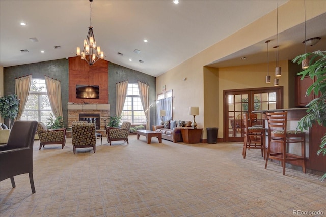 living room with high vaulted ceiling, french doors, a fireplace, a notable chandelier, and light colored carpet