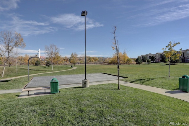 view of home's community featuring community basketball court and a lawn