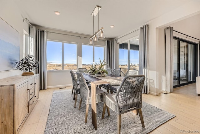 dining area with light hardwood / wood-style floors