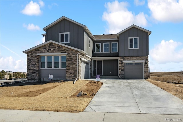 view of front facade with a garage, concrete driveway, and board and batten siding