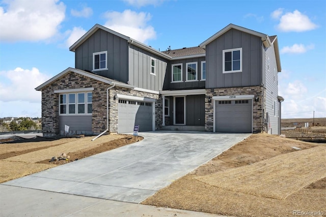 view of front of property with board and batten siding, concrete driveway, and an attached garage