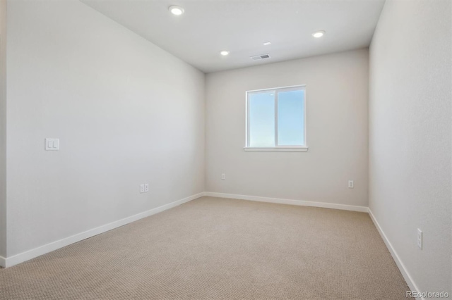 unfurnished room with baseboards, recessed lighting, visible vents, and light colored carpet