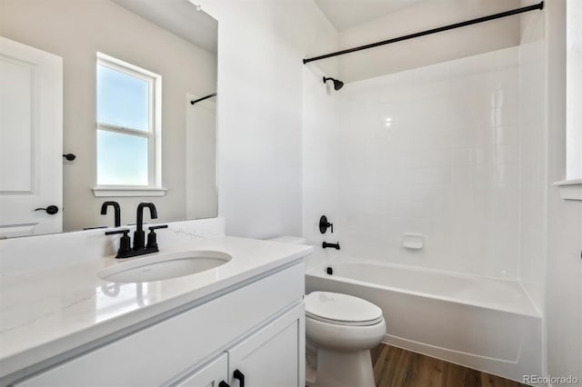 full bathroom featuring shower / bath combination, vanity, toilet, and wood finished floors