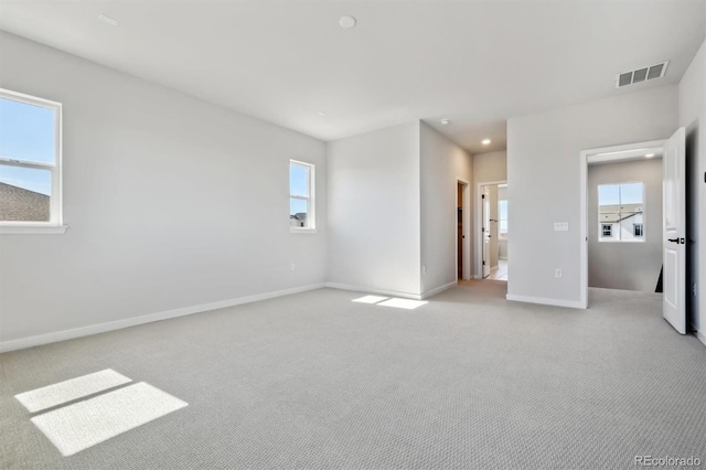 unfurnished bedroom featuring light colored carpet, visible vents, baseboards, and recessed lighting