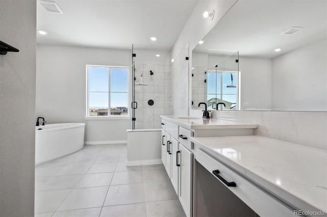 full bath featuring tile patterned flooring, a freestanding bath, vanity, a shower stall, and recessed lighting