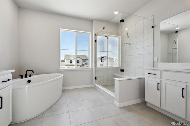 bathroom with a freestanding bath, vanity, and a shower stall