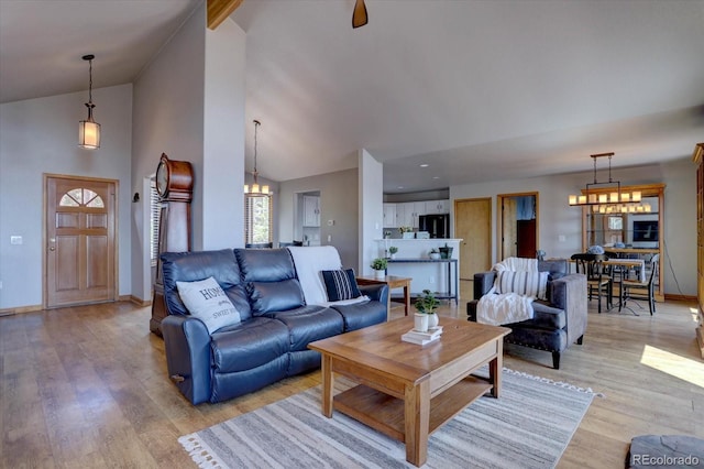 32091 Black Widow Dr, Conifer, CO 80433 - living room with a chandelier, light wood-style floors, and high vaulted ceiling