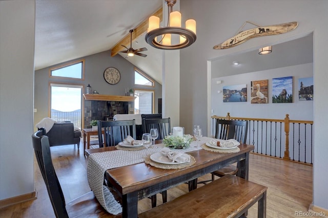 32091 Black Widow Dr, Conifer, CO 80433 - dining space with a ceiling fan, wood finished floors, beamed ceiling, and high vaulted ceiling