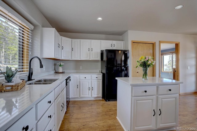 32091 Black Widow Dr, Conifer, CO 80433 - kitchen featuring freestanding refrigerator, light countertops, a center island, white cabinets, and recessed lighting