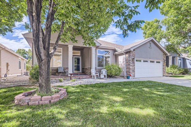 view of front of home featuring a garage, a front yard, and central AC unit