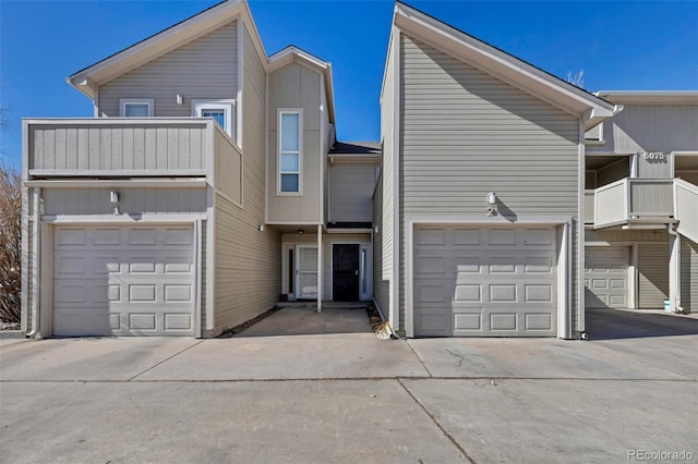 multi unit property with a balcony and an attached garage