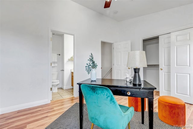 office featuring light wood-style floors, ceiling fan, and baseboards