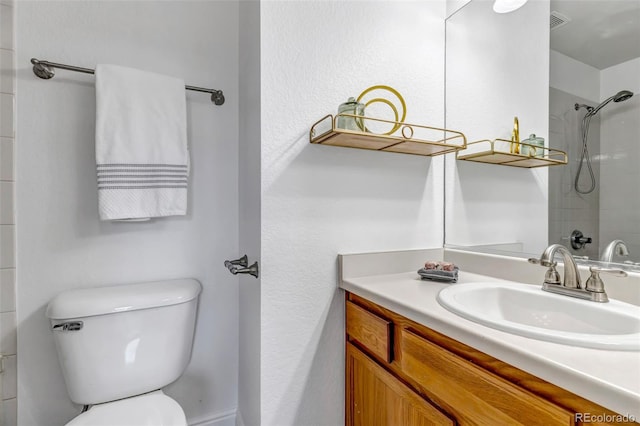 bathroom featuring visible vents, walk in shower, vanity, and toilet