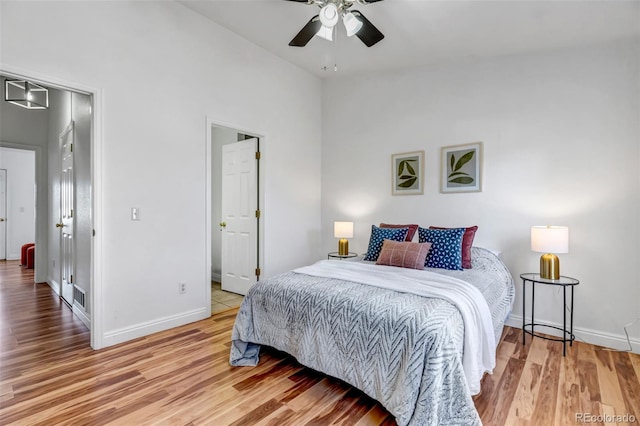 bedroom with lofted ceiling, visible vents, ceiling fan, light wood-type flooring, and baseboards