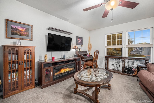 carpeted living room with ceiling fan and a textured ceiling