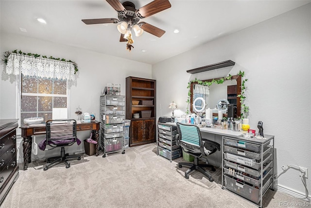 carpeted office space featuring ceiling fan