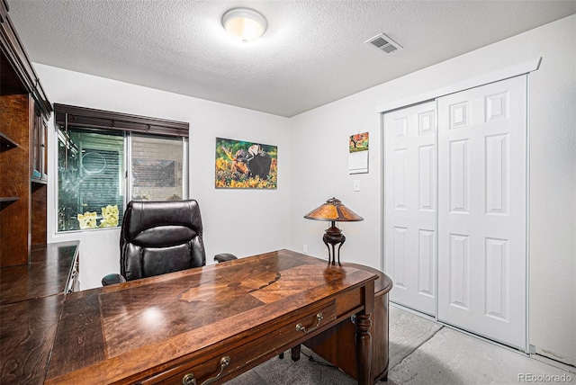 home office featuring a textured ceiling