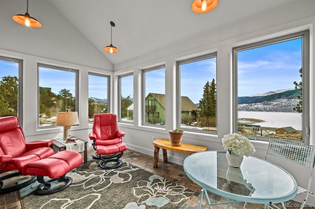 sunroom / solarium featuring vaulted ceiling and a mountain view