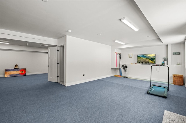 workout area with baseboards and carpet flooring