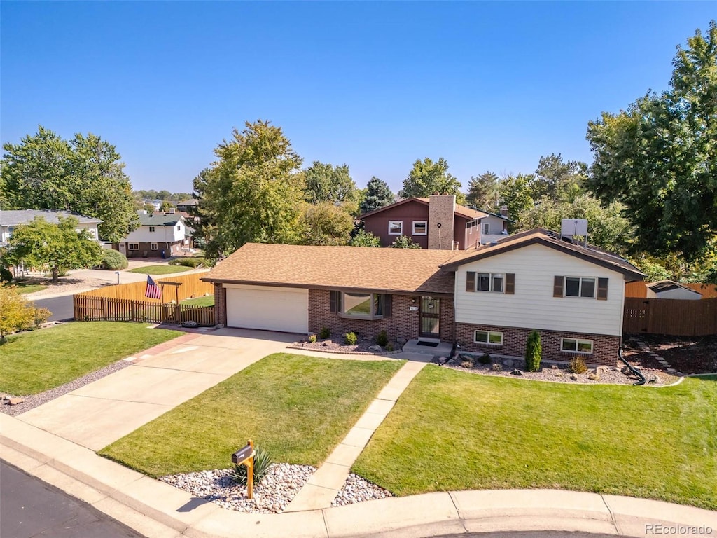 split level home featuring a garage and a front yard