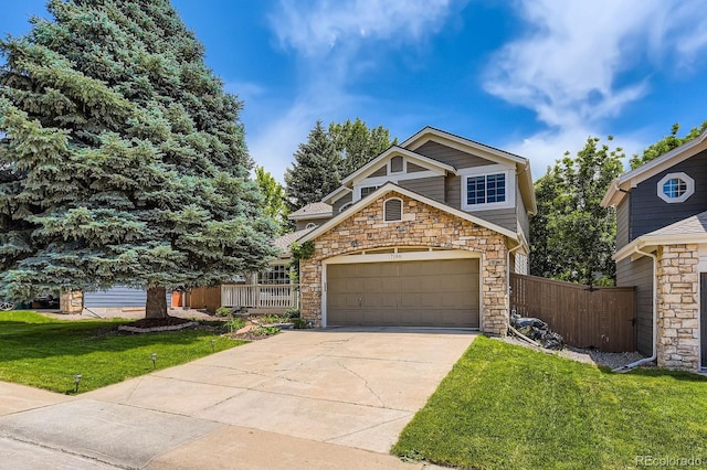 7166 Newhall Dr, Highlands Ranch, CO 80130 - view of front of home featuring stone siding, driveway, and an attached garage
