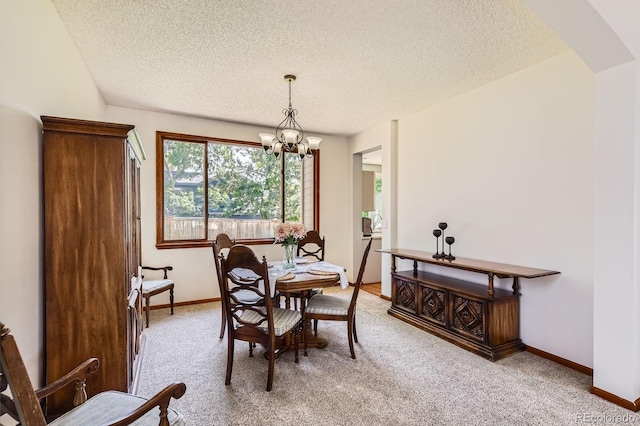 7166 Newhall Dr, Highlands Ranch, CO 80130 - dining space featuring a textured ceiling, light carpet, a chandelier, and arched walkways