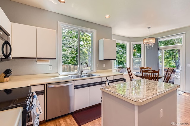 7166 Newhall Dr, Highlands Ranch, CO 80130 - kitchen with dishwasher, electric stove, light countertops, plenty of natural light, and recessed lighting