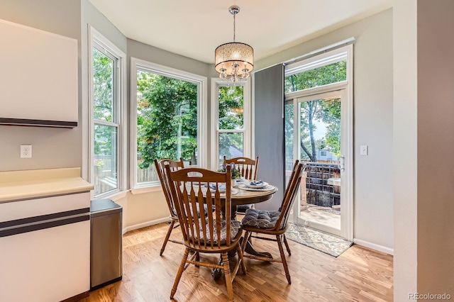 7166 Newhall Dr, Highlands Ranch, CO 80130 - dining room featuring light wood-style flooring and a chandelier