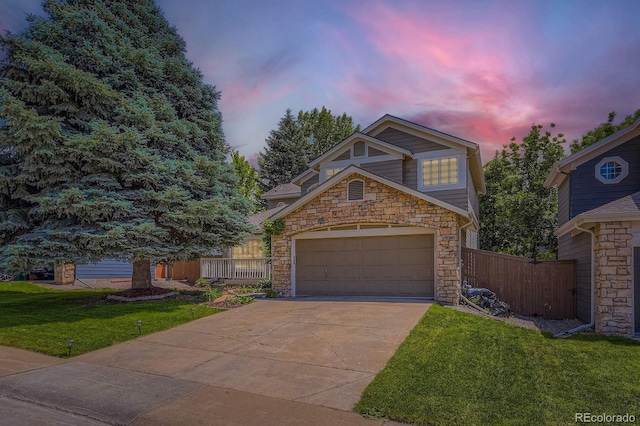 7166 Newhall Dr, Highlands Ranch, CO 80130 - view of front of property featuring stone siding, driveway, and a garage