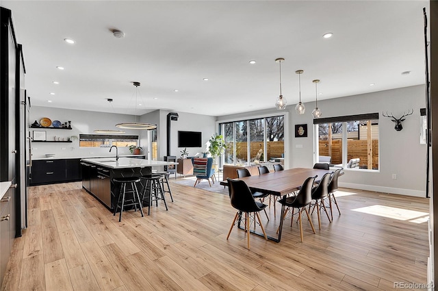 dining room with baseboards, recessed lighting, and light wood-style floors