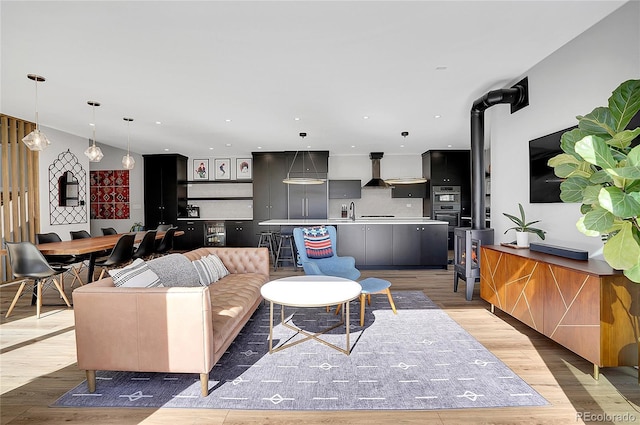 living room with light wood finished floors and recessed lighting