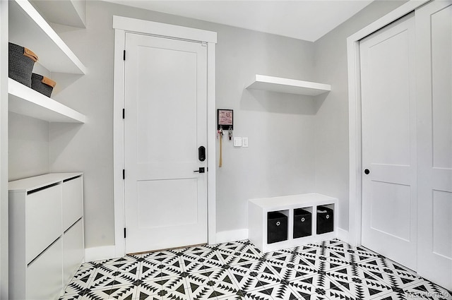 mudroom with light tile patterned flooring and baseboards