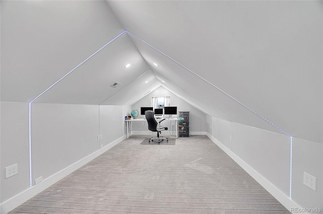 unfurnished office with baseboards and vaulted ceiling