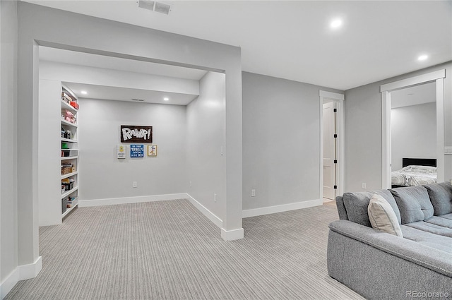 below grade area featuring recessed lighting, visible vents, baseboards, and light colored carpet