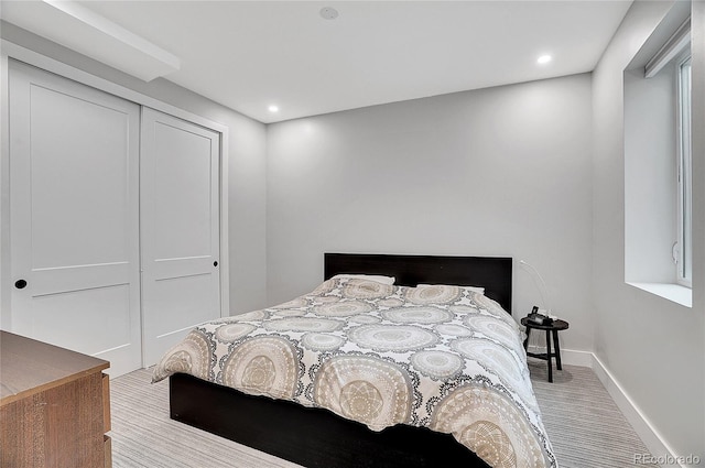 bedroom featuring baseboards, wood finished floors, a closet, and recessed lighting