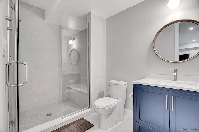 bathroom with toilet, a shower stall, tile patterned flooring, and vanity