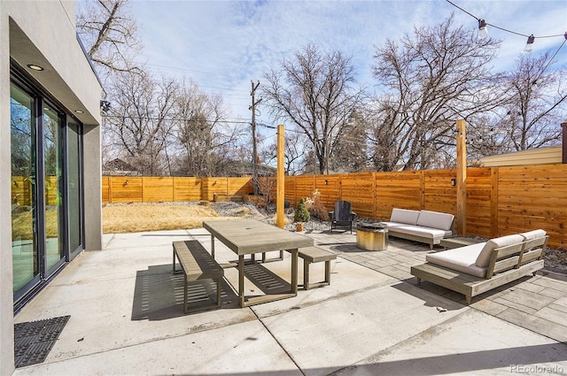 view of patio featuring an outdoor hangout area and a fenced backyard