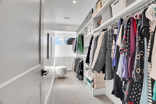 walk in closet featuring visible vents and carpet flooring