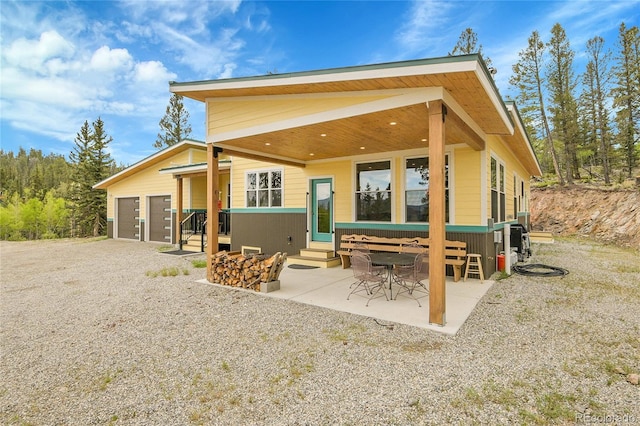 1023 Chippewa Rd, Jefferson, CO 80456 - rear view of house featuring entry steps, a patio area, and driveway