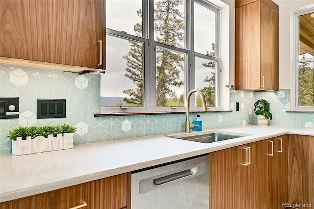 1023 Chippewa Rd, Jefferson, CO 80456 - kitchen with stainless steel dishwasher, a sink, brown cabinets, and tasteful backsplash