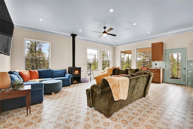 1023 Chippewa Rd, Jefferson, CO 80456 - living area with a wood stove, ceiling fan, plenty of natural light, crown molding, and recessed lighting