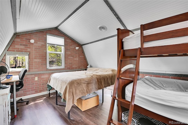 1023 Chippewa Rd, Jefferson, CO 80456 - bedroom with brick wall, hardwood / wood-style flooring, and lofted ceiling