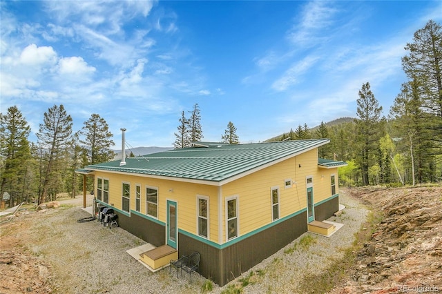 1023 Chippewa Rd, Jefferson, CO 80456 - back of house with metal roof and a forest view
