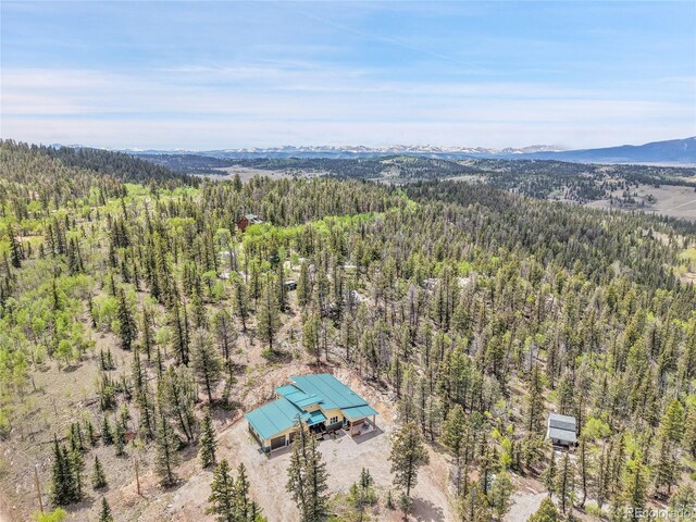 1023 Chippewa Rd, Jefferson, CO 80456 - bird's eye view of a heavily wooded area and a mountainous background